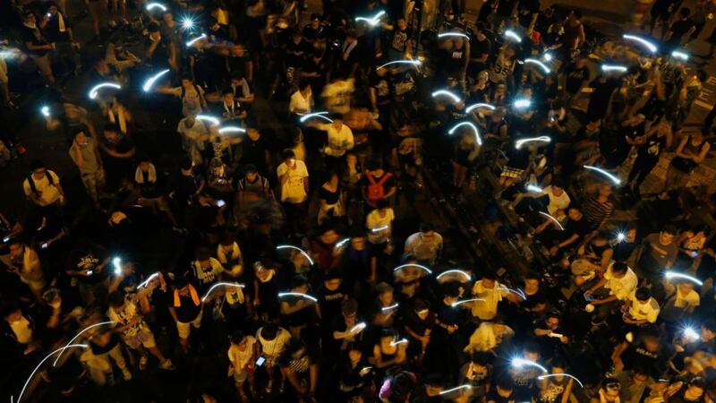Riot police step back as Hong Kong protesters maintain pressure on Beijing