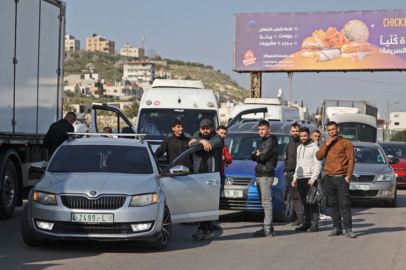 Palestinians wait as Israeli security forces search vehicles at the Hawara checkpoint, at the southern entrance to Nablus city, in the occupied West Bank on Sunday. Photograph: Jaafar Ashtiyeh/AFP/Getty