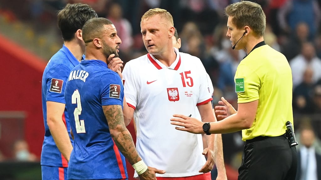 Poland’s Kamil Glik puts his hand on the face of England’s Kyle Walker as referee Daniel Siebert talks to them during the World Cup qualifier at Stadion Narodowy in Warsaw. Photograph: Ludmila Mitrega/The FA via Getty Images