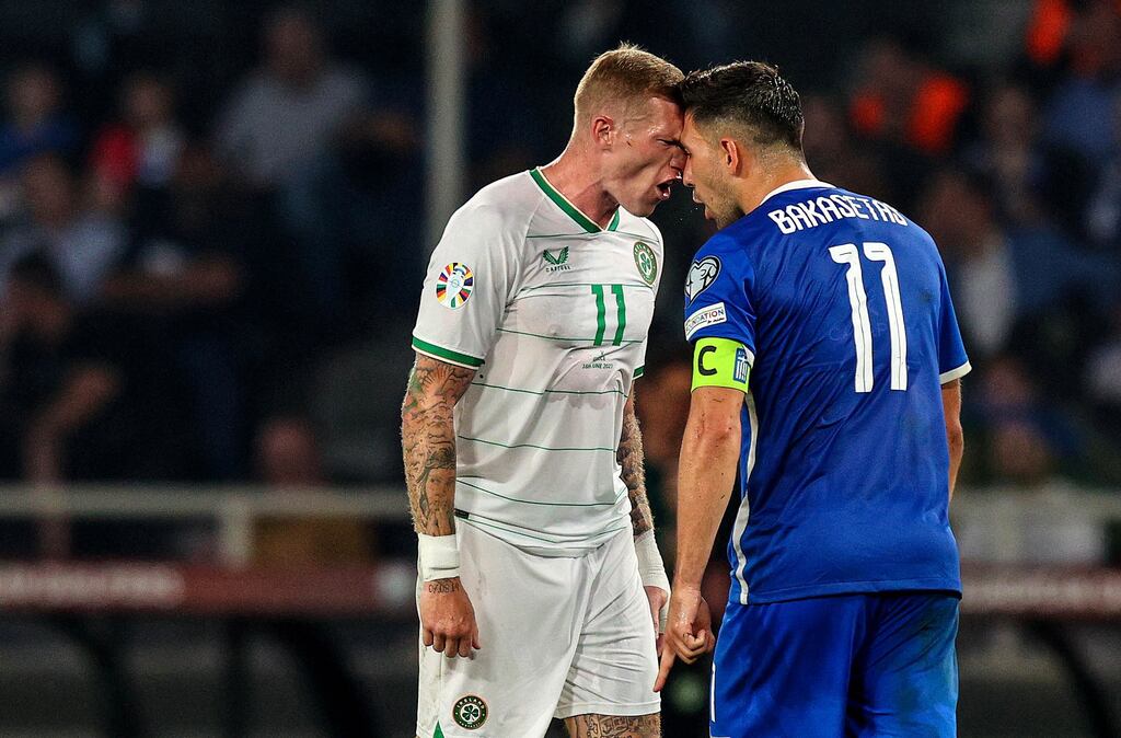 Tempers flare between Ireland's James McClean and Tasos Bakasetas of Greece during the Euro 2024 qualifier in Athens. Photograph: Ryan Byrne/Inpho