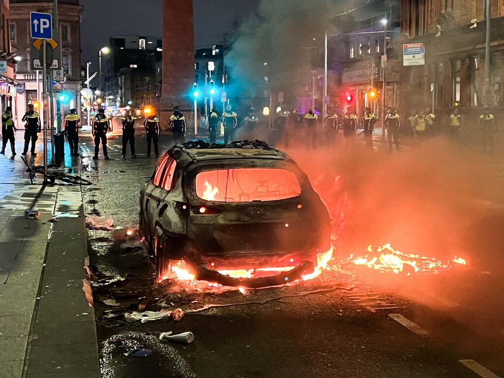 A car burns on Parnell Street in Dublin as members of the Garda Public Order Unit set up cordons. Photograph: Sam Boal/RollingNews.ie