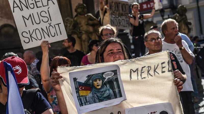 Protesters holds up a banner reading ‘Merkel must go!’ during a demonstration against German chancellor Angela Merkel in Prague, Czech Republic. Photograph: Filip Singer/EPA
