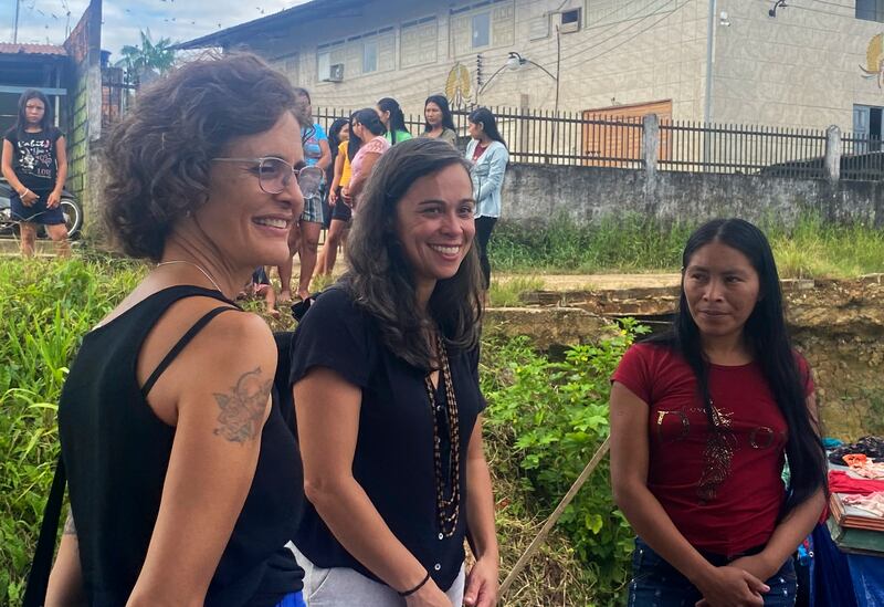 Alessandra Sampaio, widow of British journalist Dom Phillips, left, and Beatriz Matos, widow of Indigenous expert Bruno Pereira talk to indigenous people at Atalaia do Norte. Photograph: Fabiano Maisonnave/AP