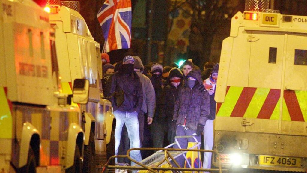 Loyalist protestors carrying Union flags clash with police outside the City Hall in Belfast last December. The absence of a strategy for flags, parades or dealing with the past has left the political establishment vulnerable to the shocks delivered by incidents and events such as the flags dispute, said Dr Paul Nolan, author of the second Northern Ireland peace monitoring report. Photograph: Paul Faith/PA