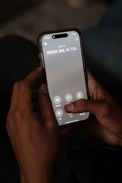 The son of a meatpacking worker who has been detained since a major raid at her plant in Omaha takes a call from her. Photograph: Erin Schaff/ The New York Times