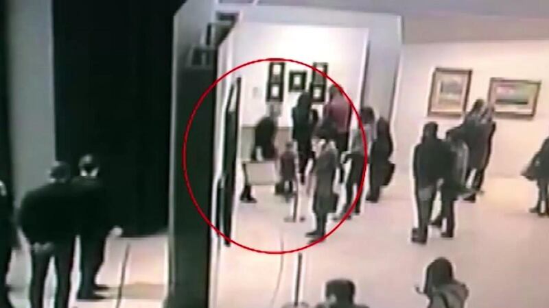 A still from a video showing the suspect leaving the exhibition room with ‘The Ai-Petri, Crimea’ painting. EPA/Russian Internal Affairs Ministry