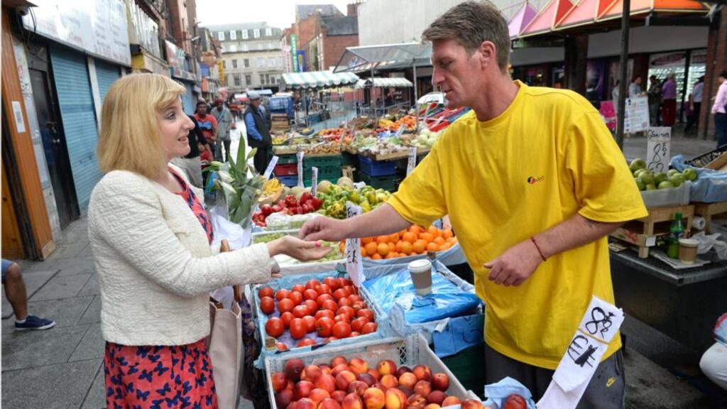 Ruth O’Connor buying from Gary Adams at his fruit and veg stall on Moore Street, Dublin. Photograph: Dara Mac Donaill