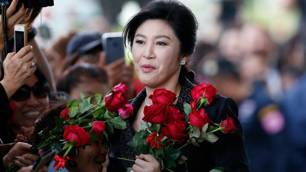 Thailand’s former prime minister Yingluck Shinawatra receives flowers from her supporters on her arrival at the Supreme Court to make final statement of the hearing in Bangkok, Thailand on August 1st. Photograph: AP Photo/Sakchai Lalit