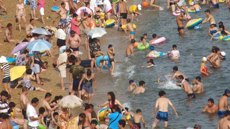 People enjoying themselves at a beach in Dalian, Liaoning Province of China. File photograph: VCG/VCG/ Getty Images