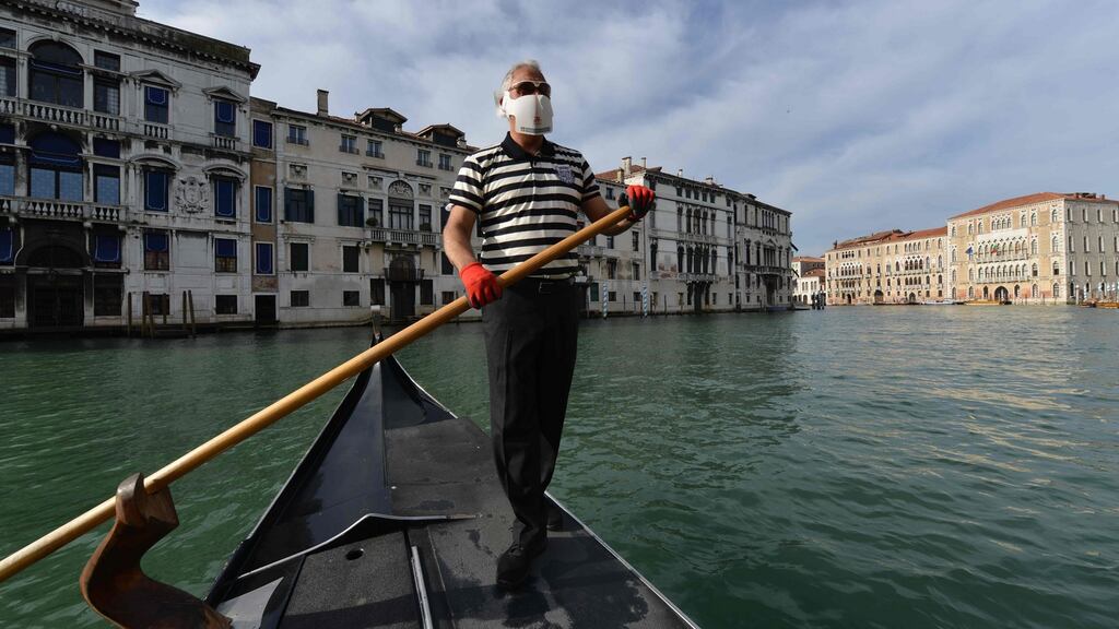 A gondolier on a Venice canal prepares to resume service as Italy eases its cornavirus restrictions. Photograph: Andrea Pattaro/AFP via Getty Images