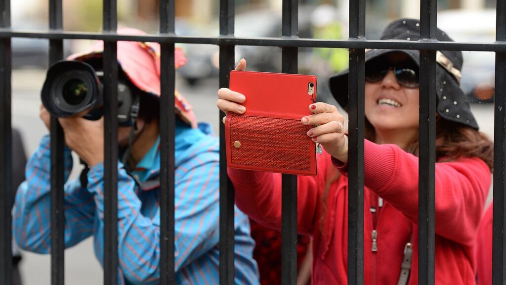 Chinese tourists capturing the stature of Oscar Wilde on Merrion Square in Dublin. Photograph: Cyril Byrne/The Irish Times