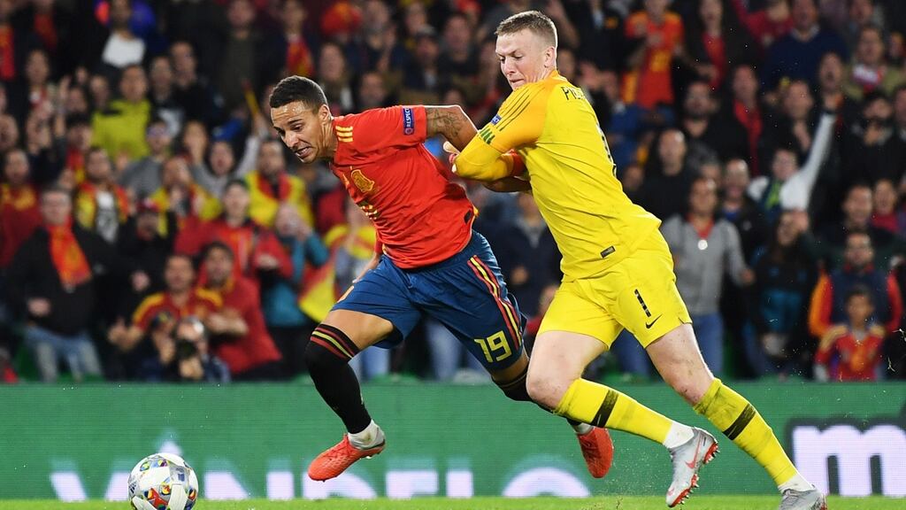 Rodrigo and Jordan Pickford tussle for the ball at Estadio Benito Villamarin in Seville. Photograph: David Ramos/Getty Images
