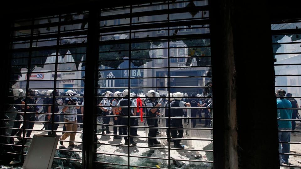 Riot police are seen from inside a damaged state bank during an anti-government protest in Istanbul today. Photograph: Murad Sezer/Reuters