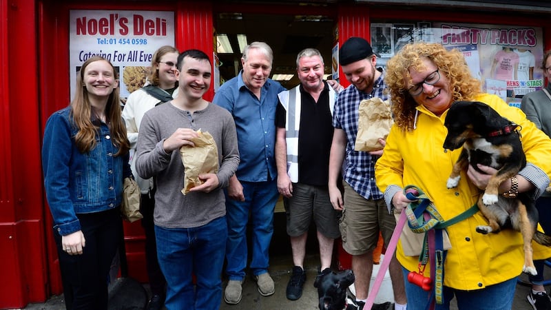 American students Stephanie Hauer, Steven Baumann, Anais Mohr, and Jacob White on Meath Street with local shopkeeper Noel Fleming, cultural officer for the Liberties James Madigan and local shopper Emer Sweeney and her dog. Photograph: Cyril Byrne