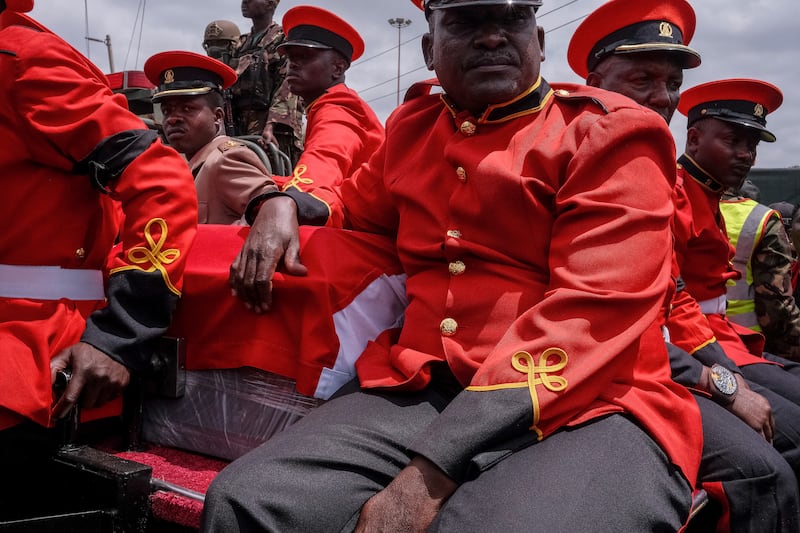 Military officials sit beside the coffin of Kenyan opposition leader Raila Odinga as they travel from Jomo Kenyatta International Airport in Nairobi. Photograph: Kabir Dhanji/AFP via Getty Images