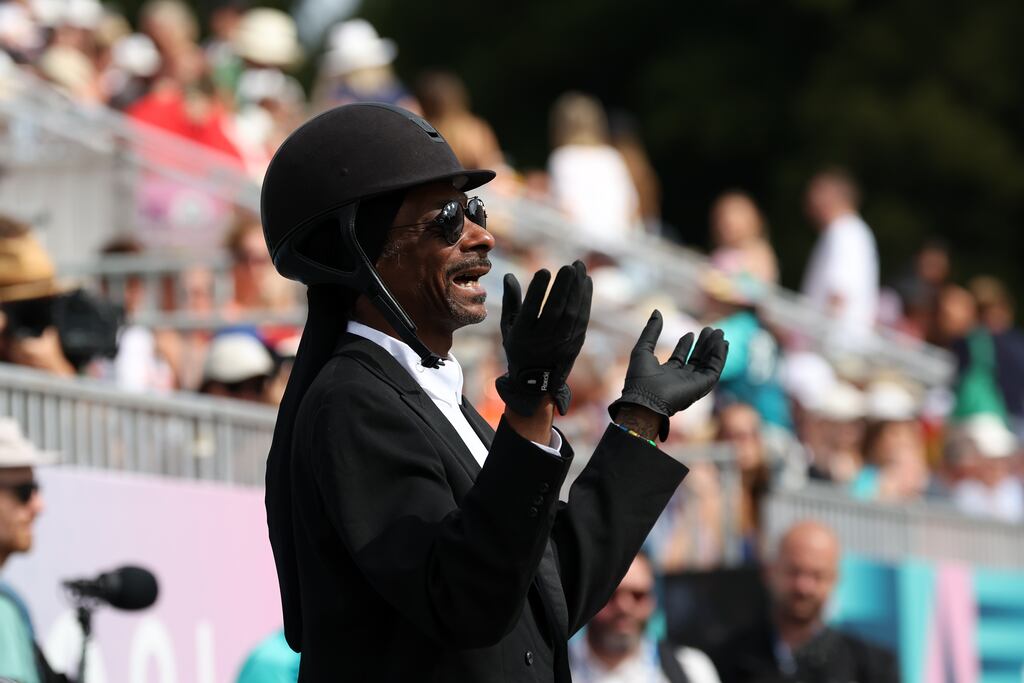 Rapper Snoop Dogg applauds the performers at the Dressage Team Grand Prix Special at Chateau de Versailles on day eight of the Olympic Games. Photograph: Mike Hewitt/Getty Images