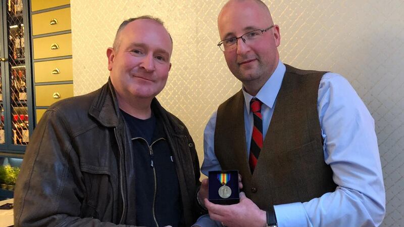 Gerard Del Delaney (right) handing over the medal of James Murray to his great grandson John.