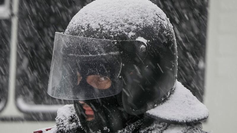 A member of the interior ministry stands guard at a pro-EU protest during snowfall on a street in Kiev today. Photograph: Gleb Garanich/Reuters