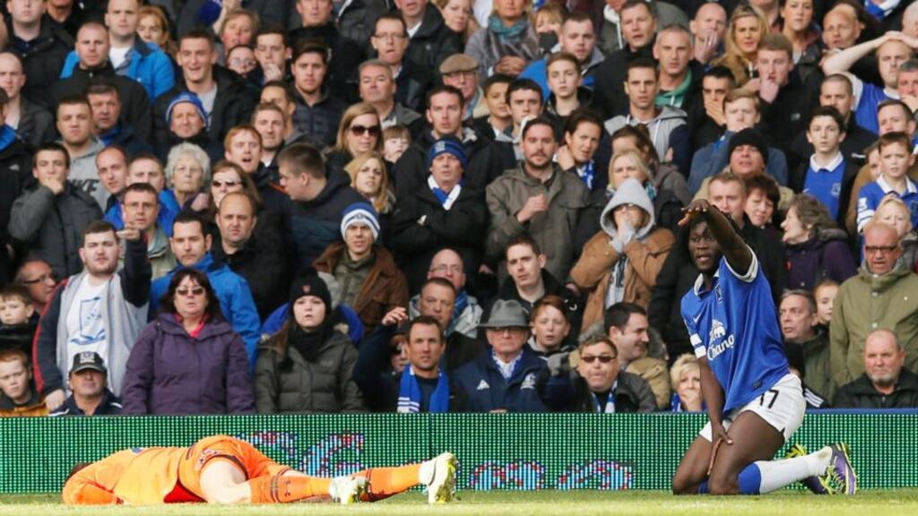 Tottenham Hotspur’s goalkeeper Hugo Lloris (left) lies injured after a collision with Everton’s Romalu Lukaku  at Goodison Park. Photograph: Phil Noble/Reuters
