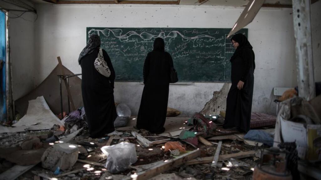 Palestinian women from the Sehweel family survey damage to a classroom after a United Nations-run school was reportedly hit by Israeli artillery shells at the Jabaliya refugee camp in the Gaza Strip. Photograph: Wissam Nassar/The New York Times