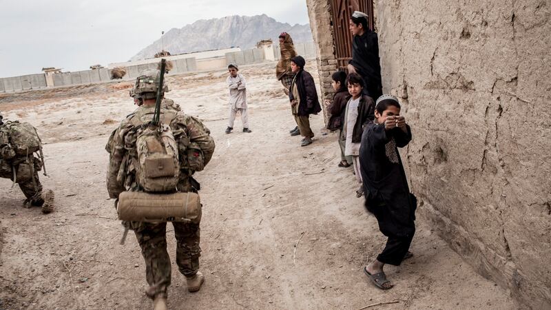 An Afghani boy plays at shooting US troops in Kandahar province. Photograph: Bryan Denton/The New York Times