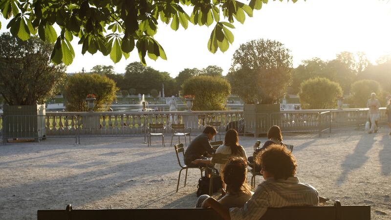 Visitors bask in the sun at the Luxembourg Gardens in Paris. Photograph: Ed Alcock/The New York Times