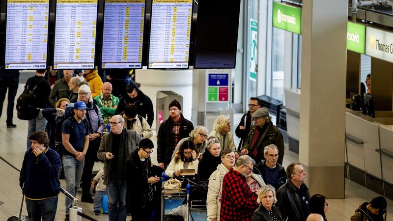 Passengers looking at displays to see if their plane will depart at Schiphol airport on Friday. Photograph: EPA