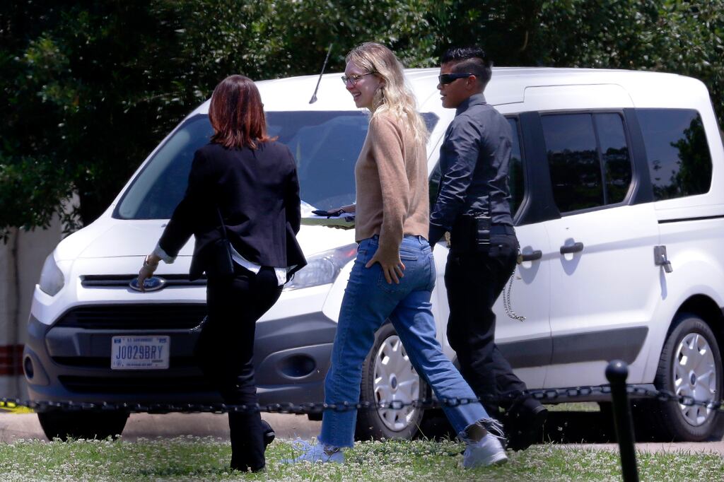 Elizabeth Holmes (centre) is escorted by prison officials into a federal women’s prison camp in Bryan, Texas. Photograph: Michael Wyke/AP/PA