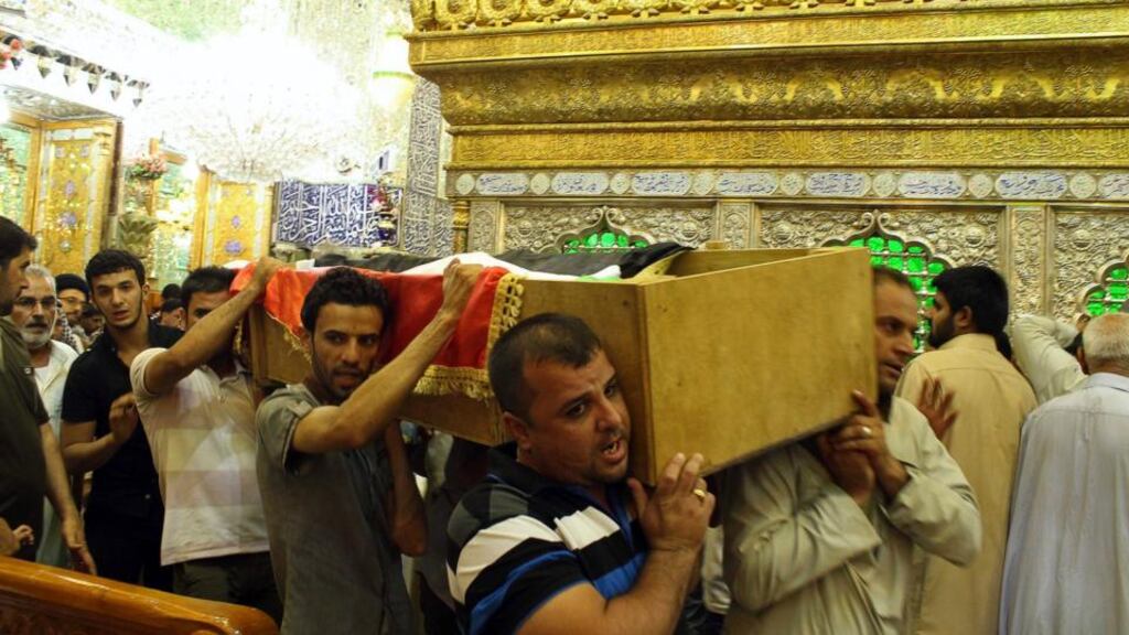 Mourners carry the coffin of a victim killed during an attack on a prison in Taji, during a funeral at the Imam Ali shrine in Najaf, 160 km south of Baghdad. Photograph: Reuters