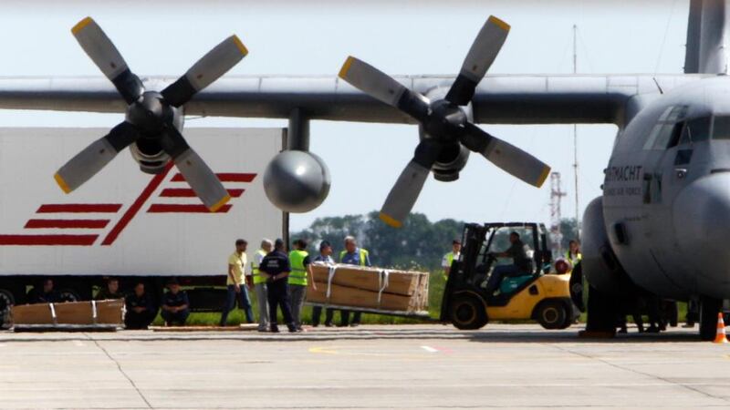 A worker uses a forklift to load coffins containing some of the remains of the victims of the crashed Malaysia Airlines MH17 plane on to a Dutch transport military aircraft before its departure to the Netherlands at Kharkiv airport today. Photograph: Valentyn Ogirenko/Reuters