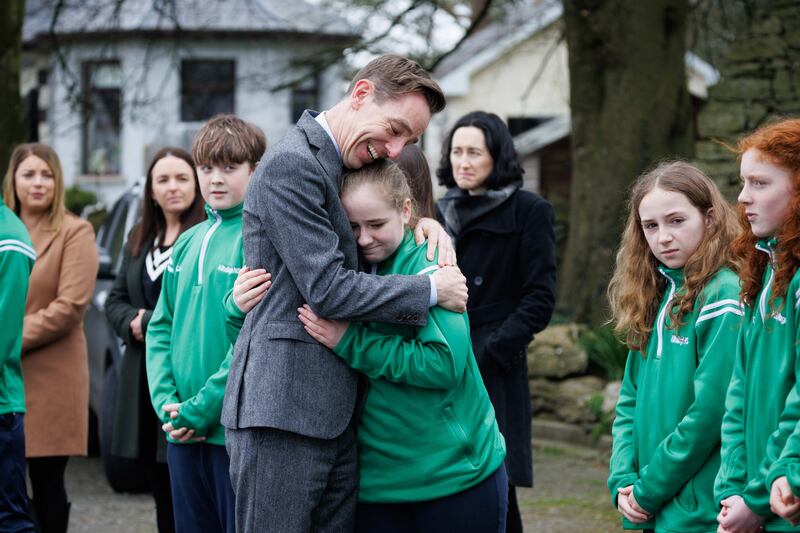 Ryan Tubridy comforting classmates of 12-year-old Saoirse Ruane during her funeral at Saints Peter and Paul Church, Kiltullagh, Co Galway. Photograph: Eamon Ward/PA Wire