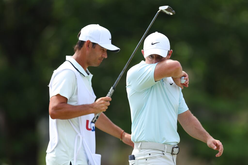 Rory McIlroy walks off a green with caddie Harry Diamond during the final round the US Open on Sunday. Photograph: Andrew Redington/Getty Images