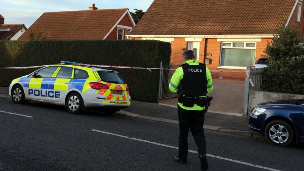 Police at the scene where a bomb was found under a former policeman’s car in east Belfast today. Photograph: Paul Faith/PA Wire