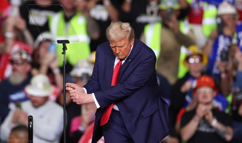 Donald Trump mimics playing golf on stage during a campaign rally last November. Photograph: Charly Triballeau/AFP via Getty Images