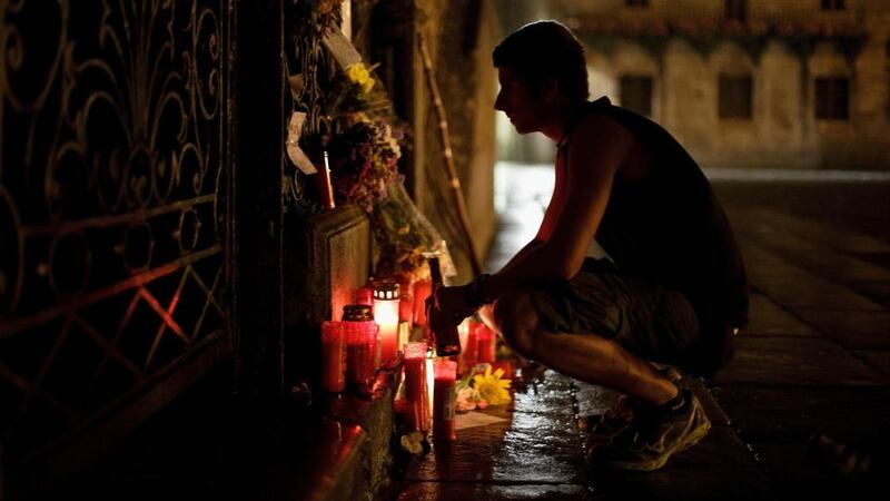 A man reads messages in memory of the train crash victims outside the Cathedral at Plaza do Obradoiro. The high speed train crashed after it derailed on a bend as it approached the north-western Spanish city of Santiago de Compostela on July 24th. Photograph: Pablo Blazquez Dominguez/Getty Images