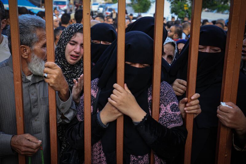 People wait to identify relatives killed in an Israeli bombardment on Khan Yunis in the southern Gaza Strip. Photograph; MAHMUD HAMS/AFP via Getty Images