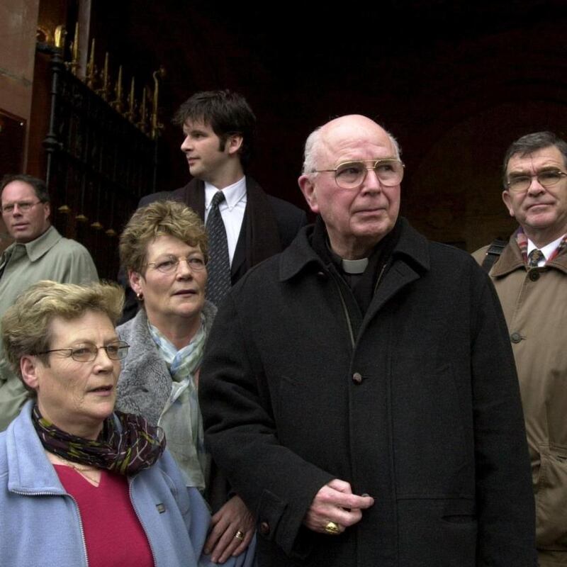 Kay Duddy and her sister Bernie accompany Bishop Edward Daly as he leaves the Guildhall in Derry after giving evidence in the Saville Inquiry in February 2001. Photograph: Trevor McBride