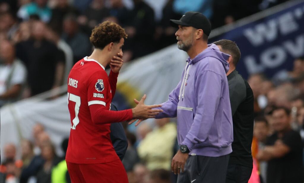 Liverpool head coach Jürgen Klopp shakes hands with Curtis Jones as he leaves the pitch after receiving a red card during the Premier League match against Tottenham Hotspur at Tottenham Hotspur Stadium. Photograph: Neil Hall/EPA