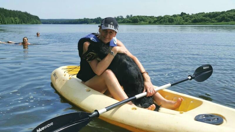 June Molloy with her dog Luna kayaking down the river