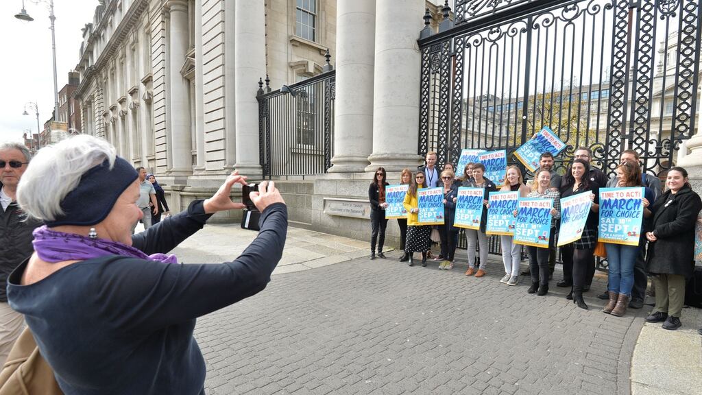 Bríd Smith TD takes a picture of the members of the Oireachtas employees for choice gathered outside the Department of the Taoiseach. Photograph: Alan Betson