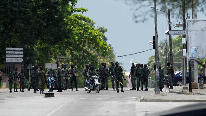 Mutinying soldiers stand next to their camp as they protest over pay in the centre of the commercial capital, Abidjan, Ivory Coast. Photograph: Luc Gnago/Reuters