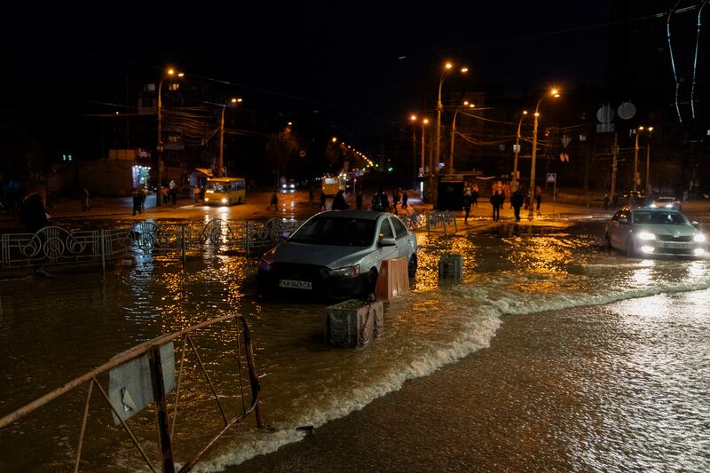 A car sits parked in water overflowing on to the street due to a damaged water pipeline following a rocket attack in Kyiv. Photograph: Tetiana Dzhafarova/Getty Images/AFP