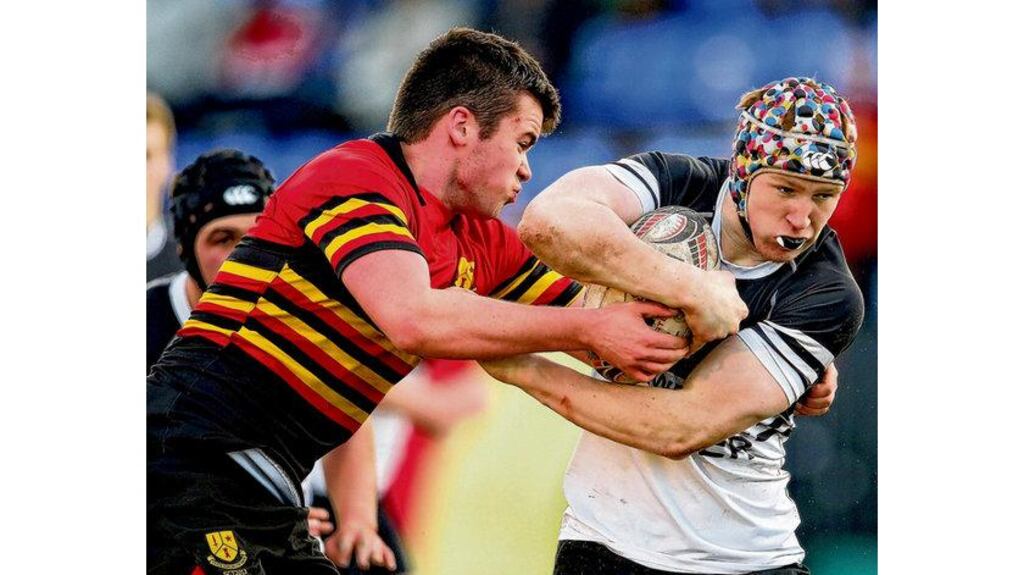 Monkstown's Kevin Patterson (left) tackles Cormac Nugent of Newbridge College. photograph: cathal noonan/inpho