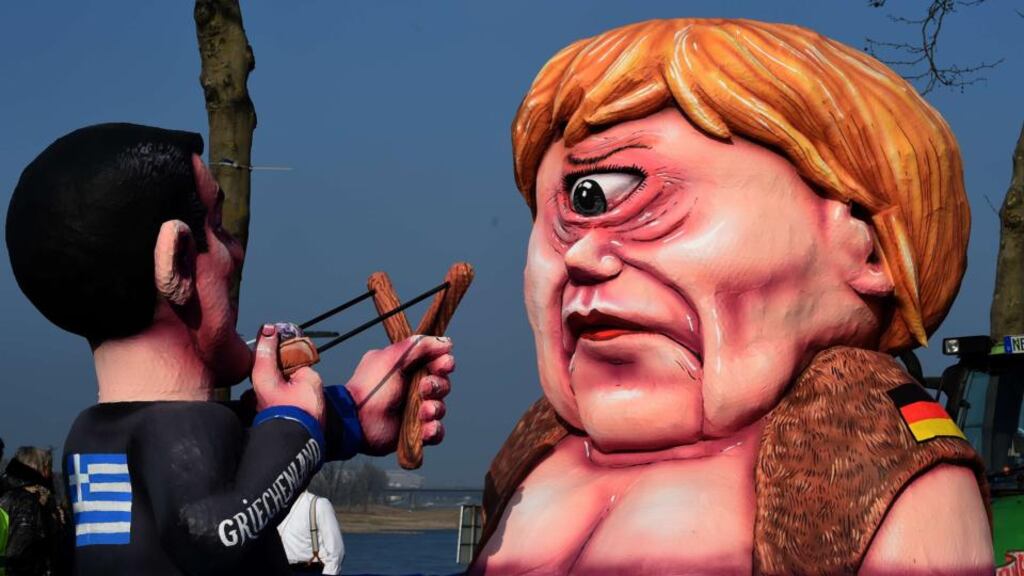 A caricature depicts Greek prime minister Alexis Tsipras and German Chancellor Angela Merkel during the traditional rosemonday carnival parade in the western German city of Duesseldorf. Photogaraph. AFP/Getty Images