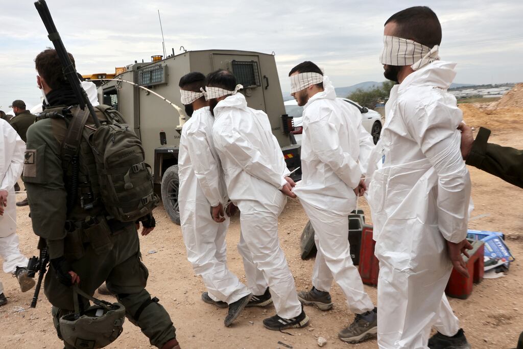 Israeli soldiers transfer Palestinian men arrested during a military raid on Jenin, near the Muqeibila crossing on the border with the occupied-West Bank. Photograph: Gil Cohen-Magen/AFP via Getty Images
