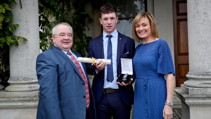 Andrew Johnston with the Ceann Comhairle Seán Ó  Fearghaíl and   Mary Kennedy after he was awarded a bronze medal   for  bravery. Photograph: Maxwell’s