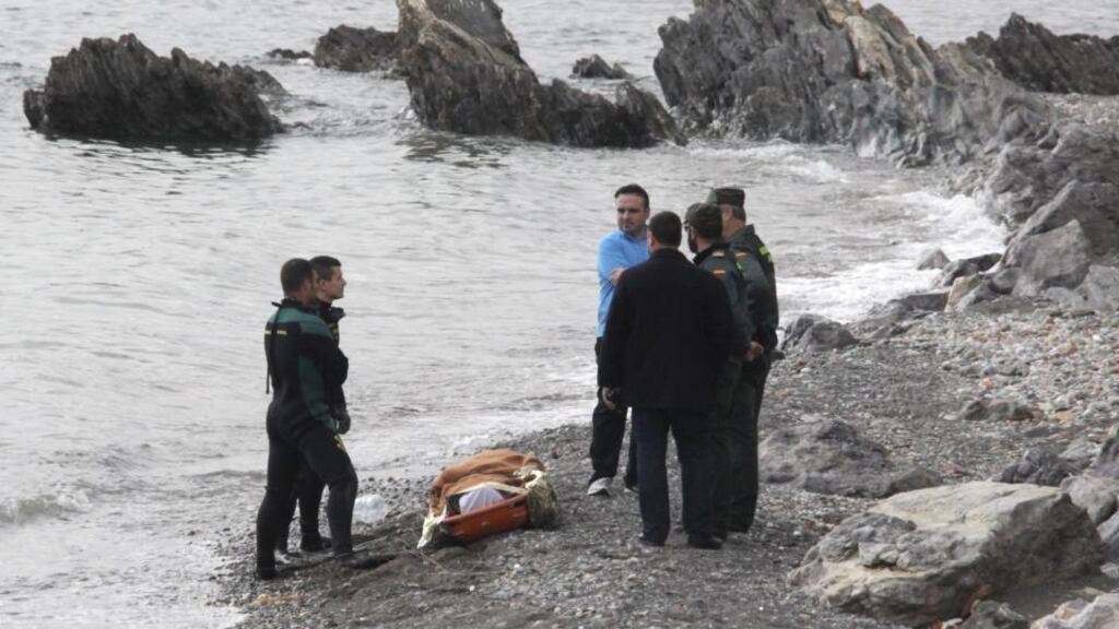 Members of the Spanish Guardia Civil stand with the body of an immigrant on a beach in the Spanish city Ceuta, north Africa, on Saturday. Photograph: EPA/Reduan