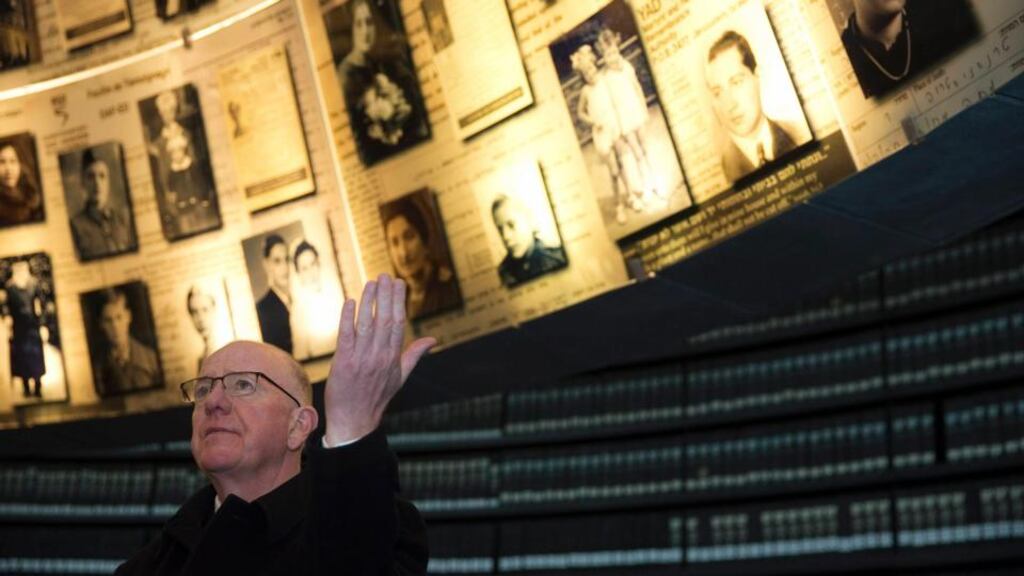 Minister for Foreign Affairs Charlie Flanagan stands under pictures of Jews killed in the Holocaust during his visit to the Hall of Names at Yad Vashem’s Holocaust History Museum in Jerusalem last Wednesday. Photograph: Ronen Zvulun/Reuters.