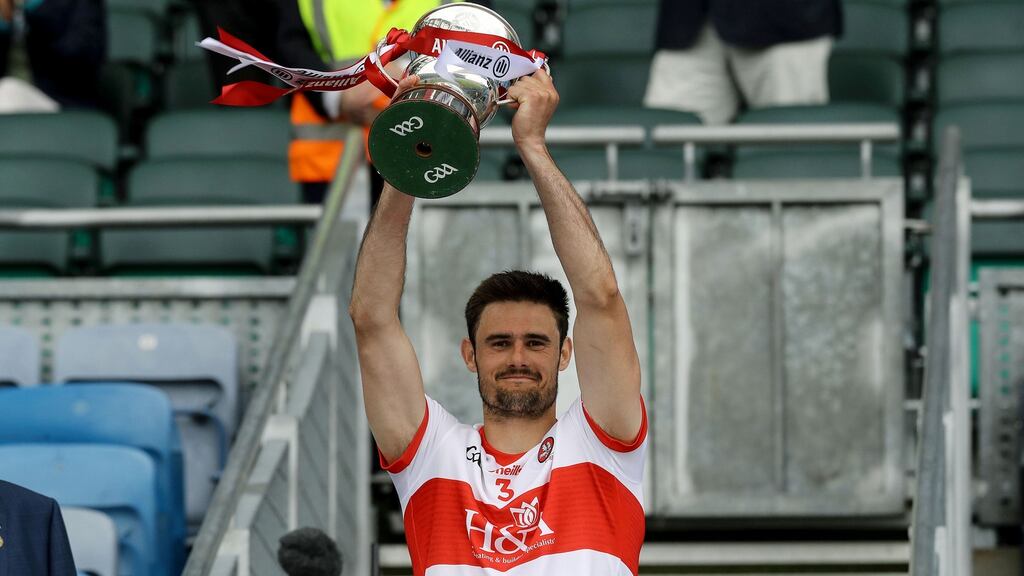 Derry’s Christy McKaigue lifts the Division 3 trophy in Croke Park. Photograph: Lorraine O’Sullivan/Inpho