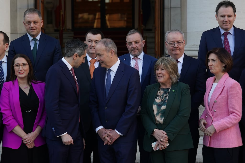 Taoiseach Micheal Martin and Tanaiste Simon Harris with newly appointed Ministers of State  outside Government Buildings.   Photo: Brian Lawless/PA Wire